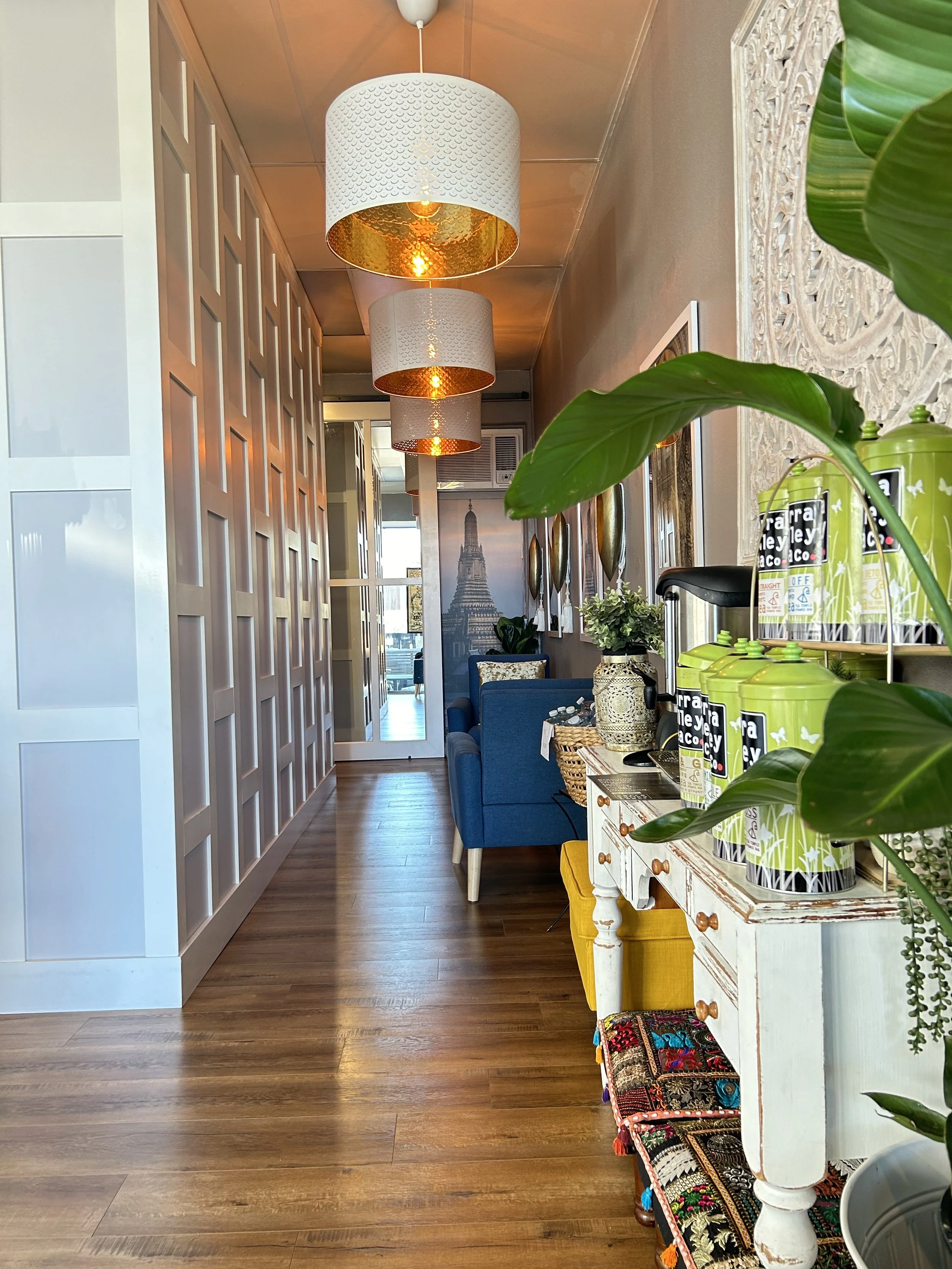 Camberwell sister location — panelled cream walls, pendant lamps, blue sofa